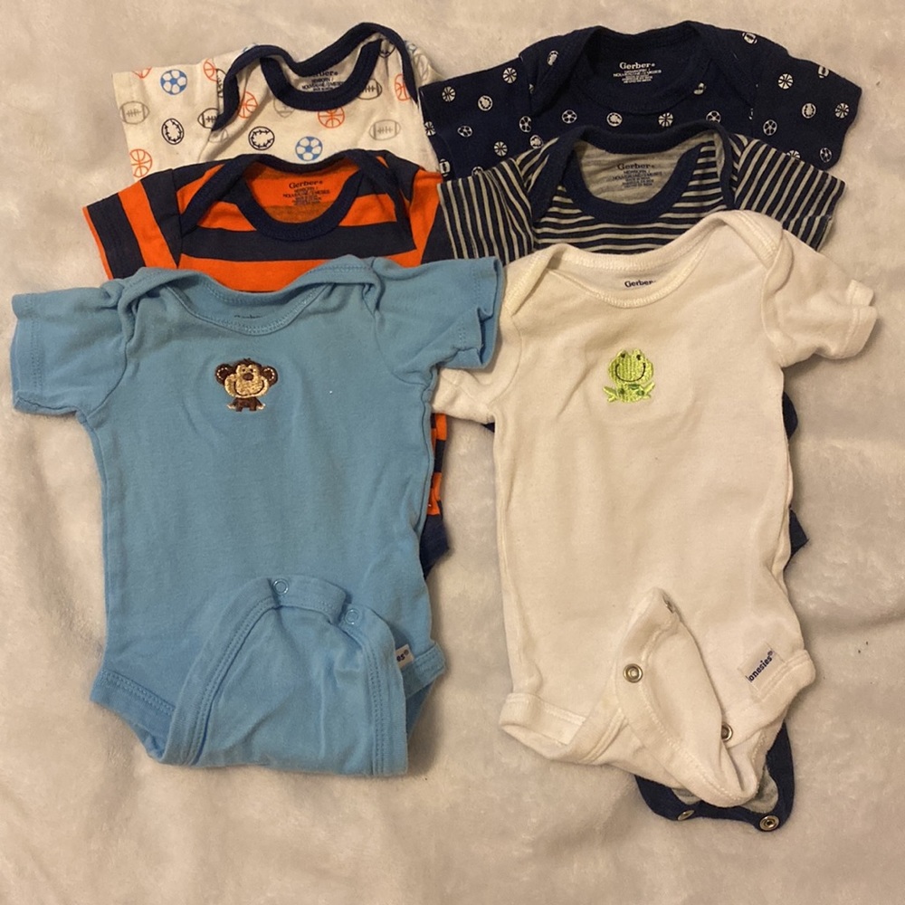 Lot of Newborn onesies pajamas hat bib socks shoes.